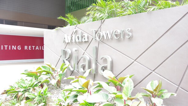 A sign for 'Avida Towers Rialta' with a modern design and green plants in front. - Avida Towers Riala (Cebu City)