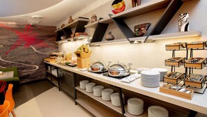 A modern breakfast buffet with various food items and decorative pottery. - ibis Styles Lima Benavides Miraflores Hotel (Lima)