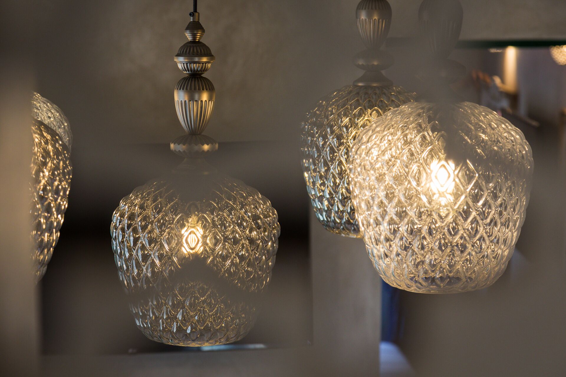 A series of crystal chandeliers with intricate designs, suspended from the ceiling.