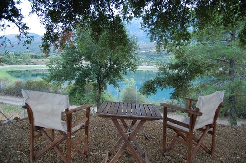 Holiday cottage with shared swimming pool and lake view in the countryside.