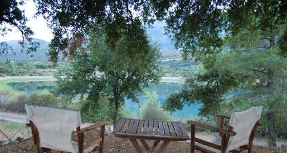 Holiday cottage with shared swimming pool and lake view in the countryside.