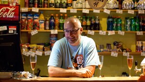 A bar with shelves stocked with various beverages, a Coca-Cola machine, and glasses on the counter. - Sporthotel BK Pod Lipou (Vedomice)