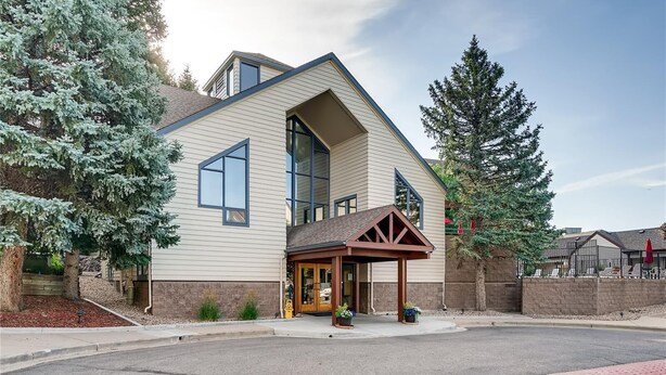 A modern two-story house with a large front porch, a garage, and a driveway. - Beautiful & Cozy Studio Condo in Denver Tech Center (Greenwood Village)