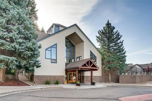 A modern two-story house with a large front porch, a garage, and a driveway. - Beautiful & Cozy Studio Condo in Denver Tech Center (Greenwood Village)