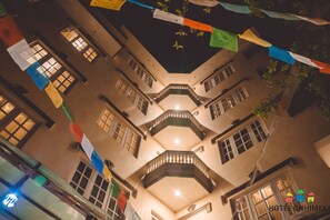 A multi-story building with balconies and windows, decorated with colorful flags. - Hotel Chhimeki (Kathmandu)