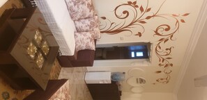Relax in a stylish room with a sofa, side table, and floral-patterned rug.
