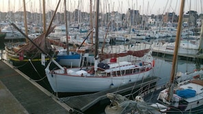 Boats are docked in a marina surrounded by nearby buildings.