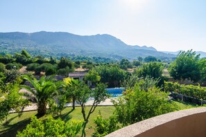 Enjoy a serene view of lush gardens and rolling hills from your balcony.