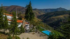 A hillside property with a swimming pool, stone buildings, and terraced vineyards. - Quinta da Portela Douro (Armamar)