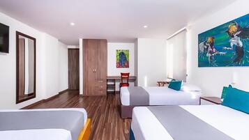 A hotel room with two beds, a desk, a chair, and a painting on the wall.