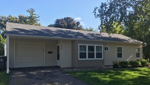 A single-story house with a garage, a front porch, and a driveway.