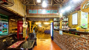 A restaurant with a sign reading "HOALU ECO HOMESTAY" and a Coca-Cola sign. - Hoa Lu Eco Homestay - Hostel (Tay Hoa Lu)