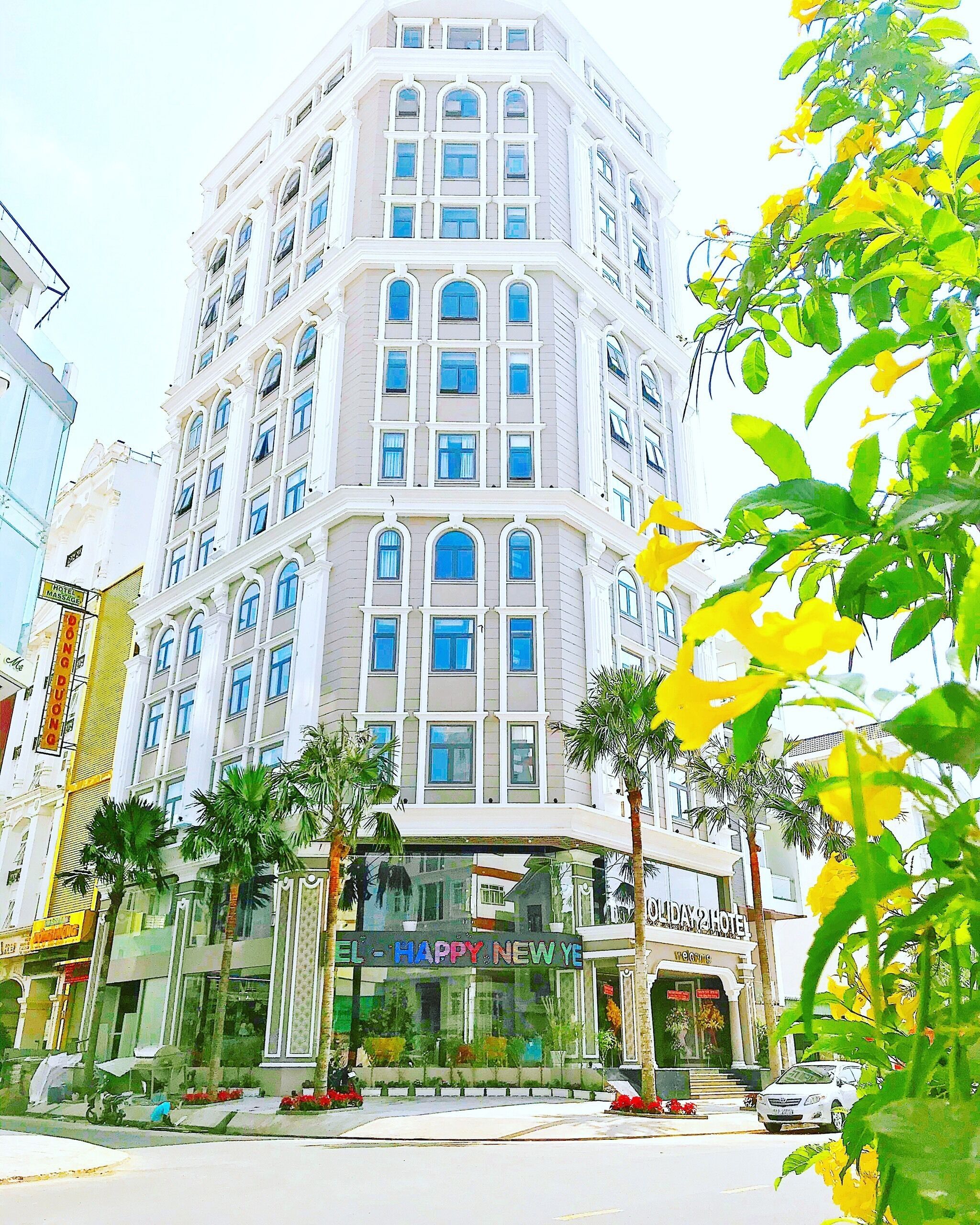 A multi-story hotel with a corner entrance, large windows, and a visible sign for 'Hotel Duomo'.