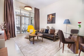 Deluxe Apartment, 1 Bedroom (1) | Living room | LCD TV - OSKENA Vacation Homes - The Medalist Tower Sport city (Dubai)