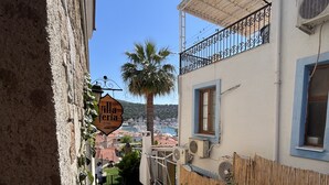 A courtyard with potted plants, a palm tree, and a sign for "Villa Eria OTEL". - Villa Veria (Cesme)