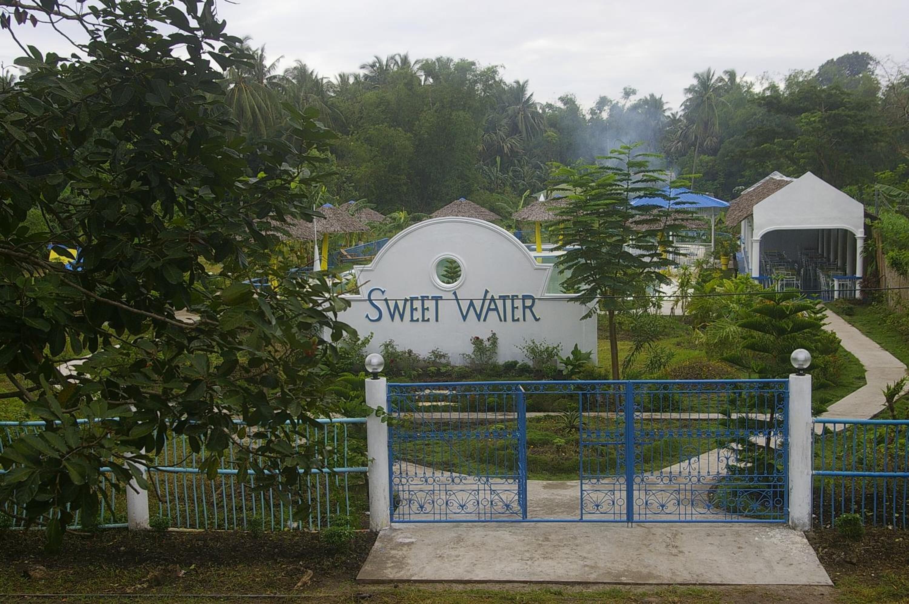 A gated entrance with a sign reading "Sweet Water."