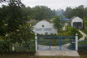 A gated entrance with a sign reading "Sweet Water." - Sweet Water Resort (Zamboanguita)