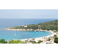 A coastal view with a beach, boats, and buildings. - 100% Happiness superb villa with sea view near beach, idyllic setting (Conca)