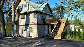 A two-story house with a steep wooden staircase leading to a deck. - Private Studio Apartment In Lewes (Lewes)