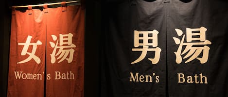 Two bathroom curtains with labels: "Women's Bath" and "Men's Bath".
