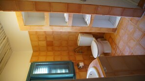 Bathroom features a toilet, sink, and window with a towel rack above the sink.