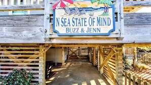 A wooden structure with a sign reading "N Sea State of Mind Buzz & Jenn". - June 27-July 4th is OPEN. CHECK THE DISCOUNTED RATES. (Corolla)
