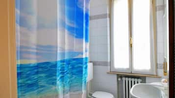 Bathtub, hair dryer, bidet, towels