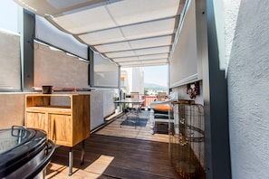 A narrow outdoor corridor with a wooden bench, a table, and a chair. - Casa Toro Luxury Town House with Rooftop Garden Sea View (Calp)