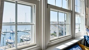 A room with large windows overlooking a marina. - Inlet Inn NC (Beaufort)