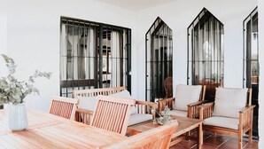 A spacious patio with wooden furniture and large windows. - Country home in Dosbarrios, Toledo (Dosbarrios)