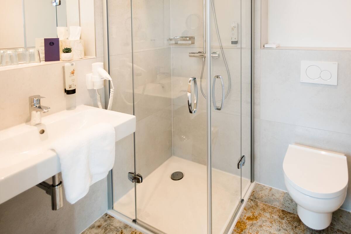 comfort double room | bathroom | shower, rainfall showerhead, hair dryer, towels