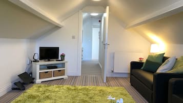 Business Apartment | Living area | 50-inch Smart TV with premium TV channels, TV, Netflix