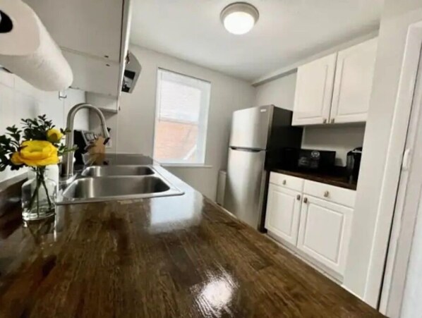 Enjoy cooking in this well-equipped kitchen with a window offering plenty of natural light.