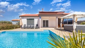 A modern villa with a swimming pool, outdoor seating, and a barbecue area. - Beautiful home in Pula (Pula)