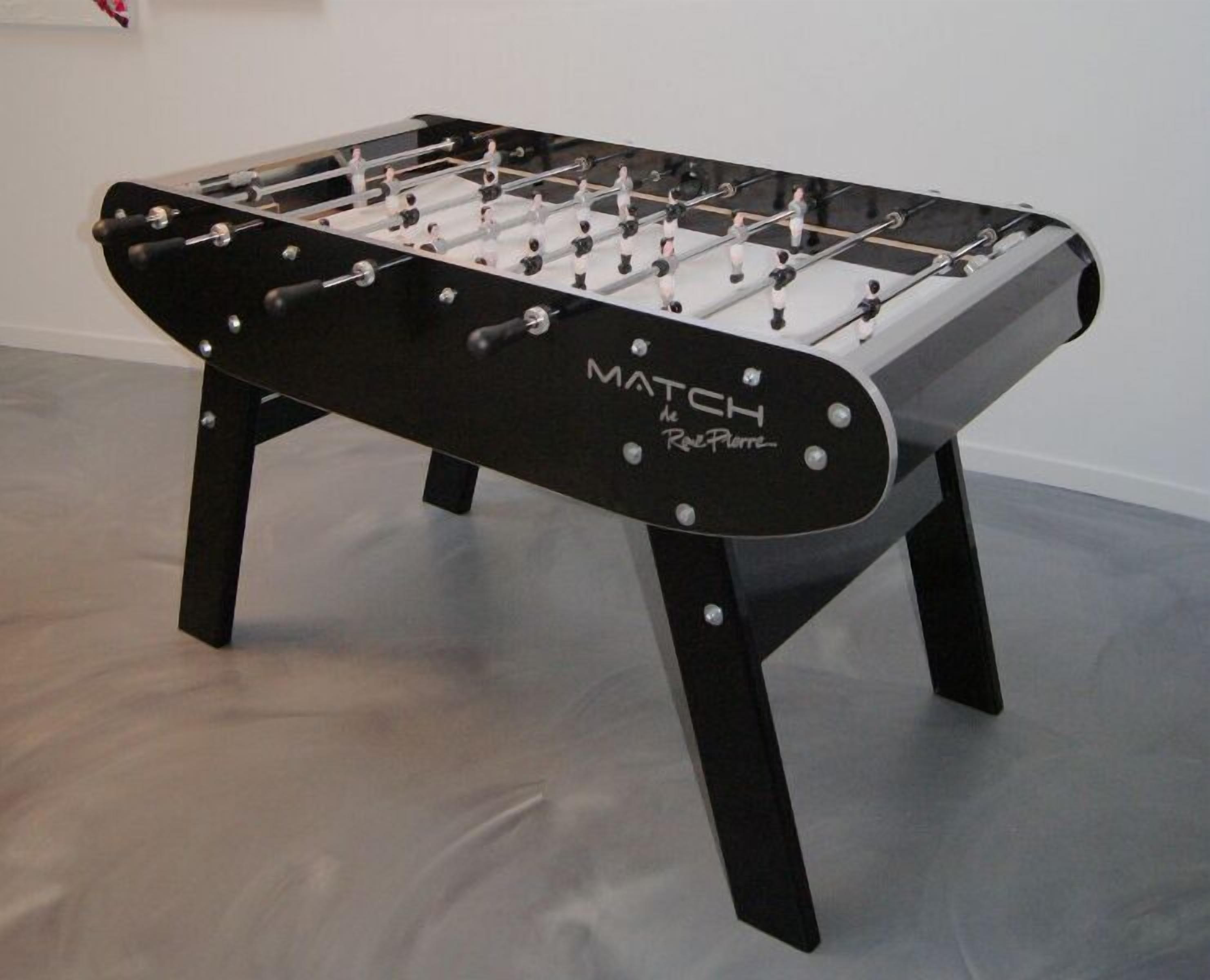 A foosball table with the text "MATCH the Red Pimpernel" on its side.