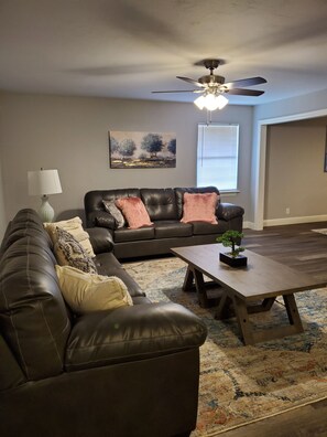 Relax in this stylish living room with a comfortable sofa, coffee table, and potted plant.