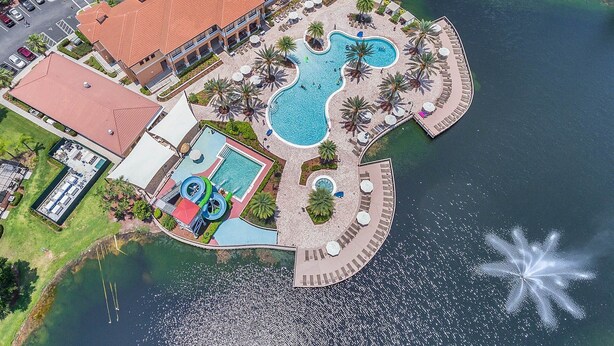 An aerial view of a resort with a large pool area, a separate children's pool, and a marina. - Spacious3 bdr w/ private jacuzzi private jacuzzi! (Kissimmee)