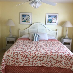 Cozy retreat with a large bed, two bedside tables, and framed artworks.