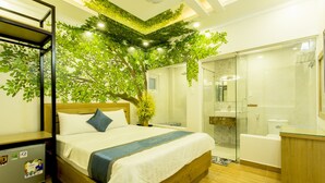 A modern hotel room with a bed, a small desk, a shower, and a bathroom. - Venice Hotel (Ho Chi Minh City)