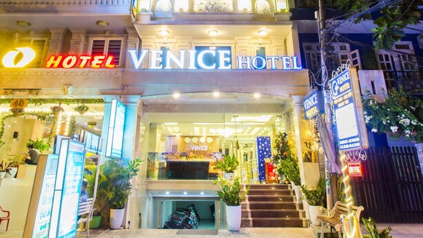 A hotel with a prominent sign reading "Venice Hotel" and a well-lit entrance with steps leading up to the door. - Venice Hotel (Ho Chi Minh City)