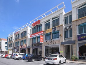 A multi-story building with various businesses including a hotel, a boutique, and a gaming center. - Hotel O Lm Residence (Miri)