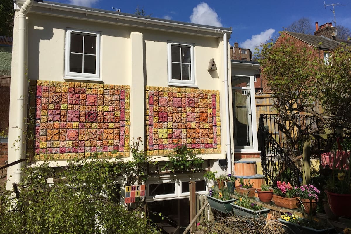 A building with a tiled facade and a sign reading "THE TILE SHOP".