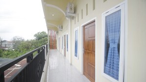 A corridor with a balcony, doors, and windows. - Hotel O Diva Residen Syariah (Jambi)