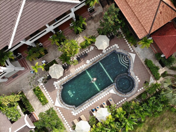 An aerial view of a resort with a swimming pool, lounge chairs, and palm trees. - ChampeySor Angkor Boutique Hotel (Siem Reap)