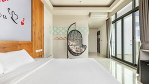 A modern hotel room with a large bed, a hanging chair, and a view through large windows. - Summer Crazy (Magong)