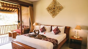 A spacious bedroom with a large bed, wooden headboard, and a decorative wall piece. - The Runik Ubud (Ubud)