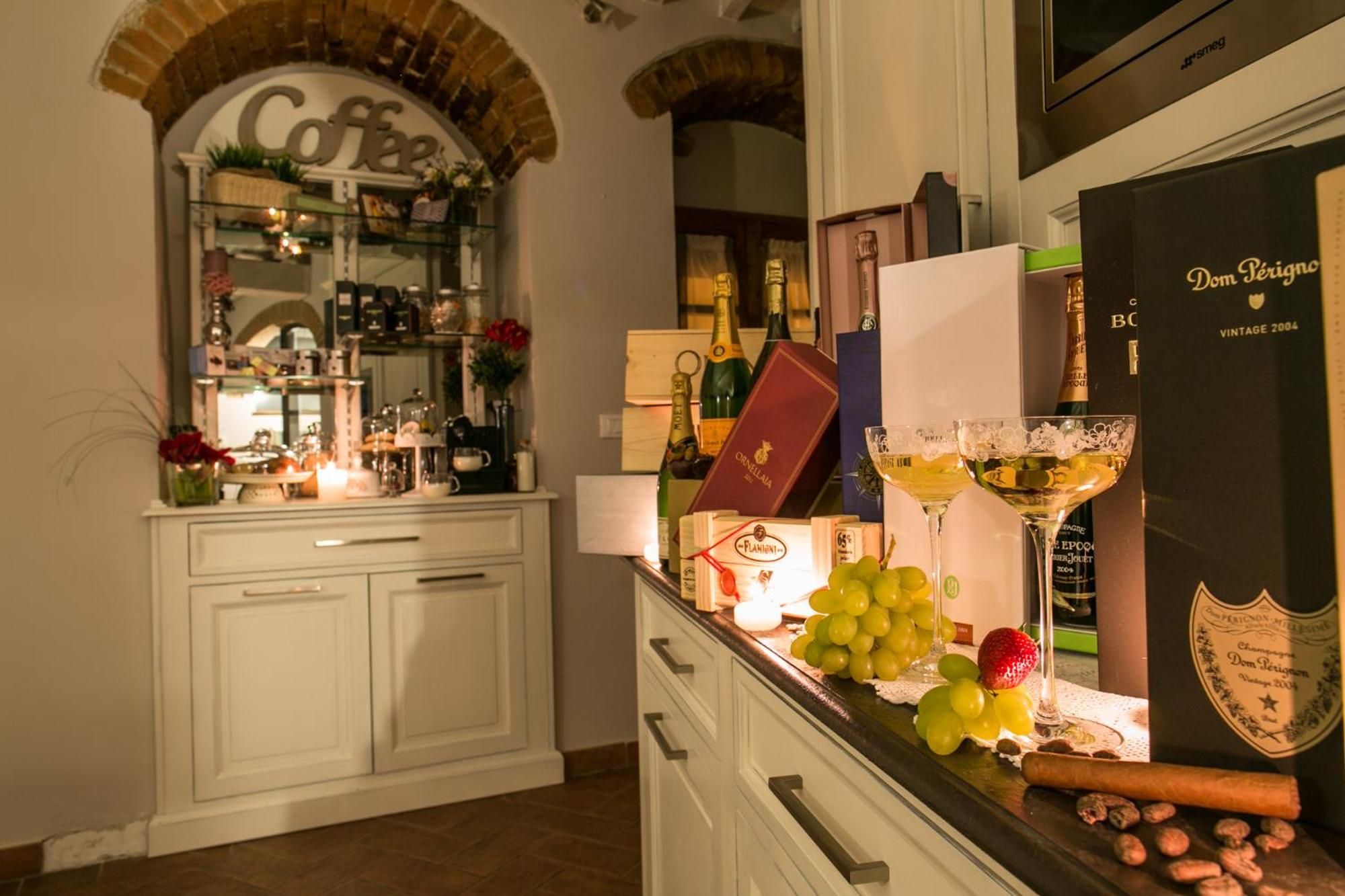 A bar area with a wine bottle, a bottle of champagne, a bottle of Dom Pérignon, a bottle of wine, a bottle of Cointreau, a bottle of gin, a bottle of vodka, a bottle of whiskey, a bottle of rum, a bottle of tequila, a bottle of vodka, a bottle of gin, a bottle of whiskey, a bottle of rum, a bottle of tequila, a bottle of vodka, a bottle of gin, a bottle of whiskey, a bottle of rum, a bottle of tequila, a bottle of vodka, a bottle of gin, a bottle of whiskey, a bottle of rum, a bottle of tequila, a bottle of vodka, a bottle of gin, a bottle of whiskey, a bottle of rum, a bottle of tequila, a bottle of vodka, a bottle of gin, a bottle of whiskey, a bottle of rum, a bottle of tequila, a bottle of vodka, a bottle of gin, a bottle of whiskey