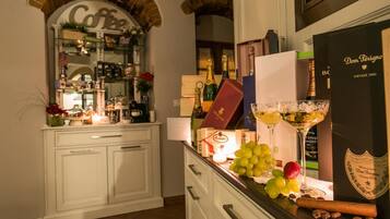 A bar area with a wine bottle, a bottle of champagne, a bottle of Dom Pérignon, a bottle of wine, a bottle of Cointreau, a bottle of gin, a bottle of vodka, a bottle of whiskey, a bottle of rum, a bottle of tequila, a bottle of vodka, a bottle of gin, a bottle of whiskey, a bottle of rum, a bottle of tequila, a bottle of vodka, a bottle of gin, a bottle of whiskey, a bottle of rum, a bottle of tequila, a bottle of vodka, a bottle of gin, a bottle of whiskey, a bottle of rum, a bottle of tequila, a bottle of vodka, a bottle of gin, a bottle of whiskey, a bottle of rum, a bottle of tequila, a bottle of vodka, a bottle of gin, a bottle of whiskey, a bottle of rum, a bottle of tequila, a bottle of vodka, a bottle of gin, a bottle of whiskey