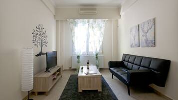 Apartment, 1 Bedroom | Living room | Flat-screen TV