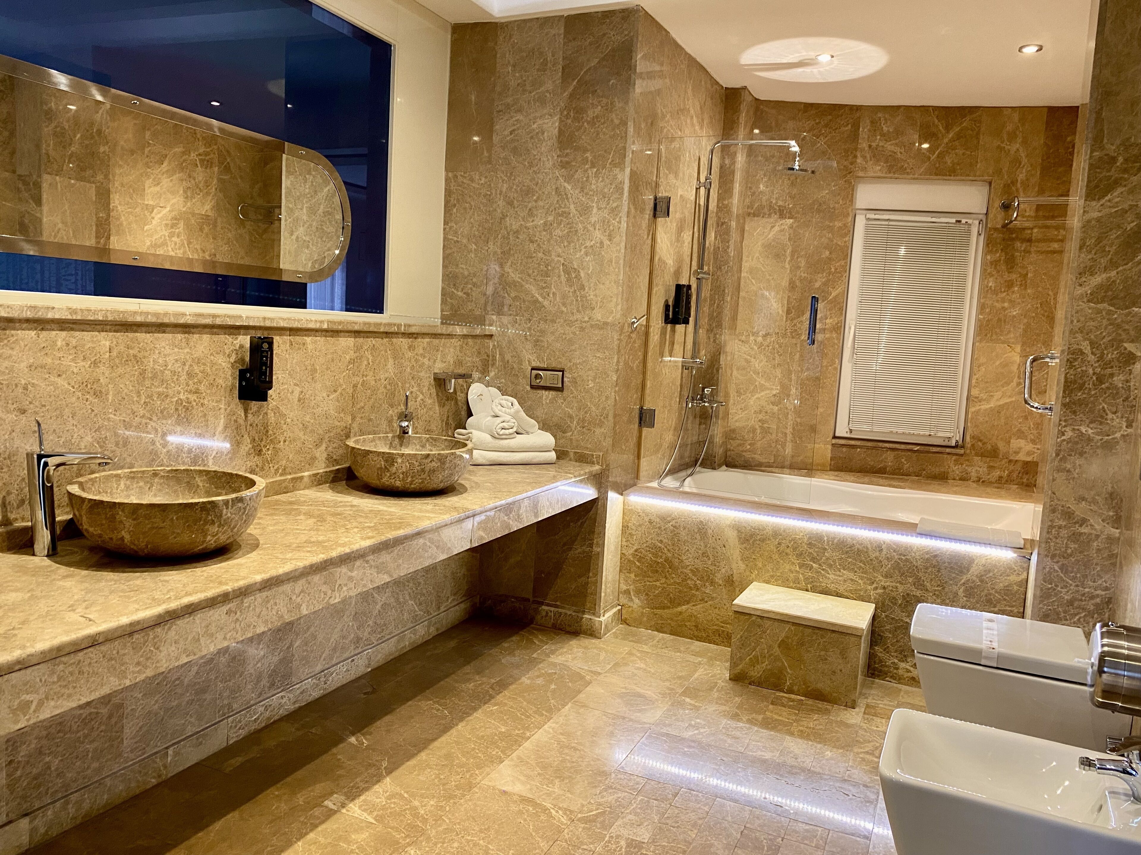 exclusive studio suite, jetted tub, city view | bathroom amenities | designer toiletries, hair dryer, slippers, towels